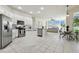 Open concept kitchen with white cabinets and adjacent dining and living areas at 10244 Shadow Branch Dr, Tampa, FL 33647