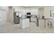 Well-lit kitchen features stainless steel appliances, white cabinets, and tile flooring at 10244 Shadow Branch Dr, Tampa, FL 33647
