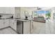 Modern kitchen with stainless steel appliances and granite countertop open to the living area at 10244 Shadow Branch Dr, Tampa, FL 33647