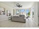 Living room with a comfortable sofa, ample natural light, and a stylish ceiling fan at 10244 Shadow Branch Dr, Tampa, FL 33647
