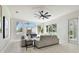 Bright living room with large windows, comfortable seating, and modern decor at 10244 Shadow Branch Dr, Tampa, FL 33647