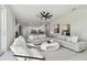 Bright, open living room with contemporary decor, comfortable seating, and a view into the kitchen at 10244 Shadow Branch Dr, Tampa, FL 33647