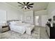 Comfortable main bedroom with ceiling fan, elegant bedding, and neutral tones, creating a relaxing atmosphere at 10244 Shadow Branch Dr, Tampa, FL 33647