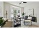 Well-lit home office with bay windows, a modern desk, and comfortable seating area at 10244 Shadow Branch Dr, Tampa, FL 33647