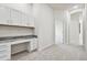 Bright office space features built-in desk with granite countertop, drawers and cabinet storage, and neutral paint at 10244 Shadow Branch Dr, Tampa, FL 33647