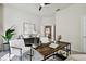 Office featuring a wooden desk, neutral paint, and views to the doorway and backyard at 10244 Shadow Branch Dr, Tampa, FL 33647
