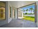 A view of the covered back patio and a glimpse of the sunny back yard at 10244 Shadow Branch Dr, Tampa, FL 33647