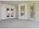 Covered patio featuring white walls, windows, and doors to the backyard at 10244 Shadow Branch Dr, Tampa, FL 33647