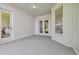 Covered patio featuring white walls, windows, and doors to the backyard at 10244 Shadow Branch Dr, Tampa, FL 33647