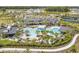 A stunning aerial view of the resort-style community pool surrounded by palm trees and lounging areas at 10244 Shadow Branch Dr, Tampa, FL 33647