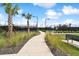 View of community tennis courts and walking path bordered by lush landscaping at 10244 Shadow Branch Dr, Tampa, FL 33647