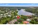 Aerial view of a waterfront home in a residential neighborhood with nearby lake at 10310 Carroll Cove Pl, Tampa, FL 33612