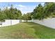 Fenced backyard featuring a well-manicured lawn with a young shade tree at 10310 Carroll Cove Pl, Tampa, FL 33612