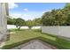 Spacious backyard with a well-maintained lawn and privacy fence at 10310 Carroll Cove Pl, Tampa, FL 33612
