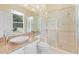 Bright bathroom featuring a glass-enclosed shower, granite countertops, and ample natural light at 10310 Carroll Cove Pl, Tampa, FL 33612