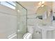 Bathroom featuring glass enclosed shower, white tiled walls, and pedestal sink at 10310 Carroll Cove Pl, Tampa, FL 33612