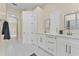 Bathroom featuring double vanity with gold hardware, modern cabinets, and decorative mirrors at 10310 Carroll Cove Pl, Tampa, FL 33612
