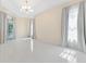 Bright bedroom with tile flooring, large windows, and plenty of natural light at 10310 Carroll Cove Pl, Tampa, FL 33612