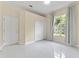 Bedroom featuring neutral walls, marble floors, and large window with nature views at 10310 Carroll Cove Pl, Tampa, FL 33612