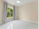 Bedroom with marble tile flooring, large window, and neutral walls at 10310 Carroll Cove Pl, Tampa, FL 33612
