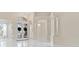 Spacious foyer with soaring ceilings, marble flooring, ornate lighting fixtures, and decorative columns at 10310 Carroll Cove Pl, Tampa, FL 33612