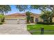 Beautiful home with a three-car garage, paver driveway, and manicured front lawn at 10310 Carroll Cove Pl, Tampa, FL 33612