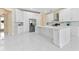 Bright kitchen with white cabinetry, marble countertops, stainless steel appliances, and large island at 10310 Carroll Cove Pl, Tampa, FL 33612