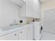 Laundry room featuring storage cabinets and a convenient washing machine at 10310 Carroll Cove Pl, Tampa, FL 33612