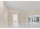 Bright living room with sleek marble flooring, decorative columns, and sliding doors to a covered patio at 10310 Carroll Cove Pl, Tampa, FL 33612