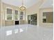 Bright living room with high ceilings, fireplace, large windows, tile flooring, and view to the patio at 10310 Carroll Cove Pl, Tampa, FL 33612