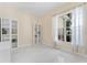 Bright office space featuring built-in bookcases, tile floors, and natural light at 10310 Carroll Cove Pl, Tampa, FL 33612