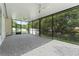 Screened-in patio area with ceiling fans and views of the surrounding greenery at 10310 Carroll Cove Pl, Tampa, FL 33612