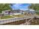 Canal-front home with a screened-in porch and grassy yard at 106 N Saint George Cir, Apollo Beach, FL 33572