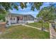 Exterior view featuring a lush green backyard with access to a serene canal at 106 N Saint George Cir, Apollo Beach, FL 33572