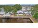 Waterfront property featuring a dock, screened-in porch, and meticulously maintained grassy yard at 106 N Saint George Cir, Apollo Beach, FL 33572