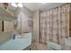 Bathroom with blue countertop, lavatory, shower, curtain, and towel rack at 106 N Saint George Cir, Apollo Beach, FL 33572