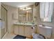 Functional bathroom with a single sink vanity, a large mirror, and a shower with sliding glass doors at 106 N Saint George Cir, Apollo Beach, FL 33572