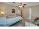 Cozy bedroom featuring a metal frame bed, ceiling fan, carpet flooring, and neutral decor at 106 N Saint George Cir, Apollo Beach, FL 33572