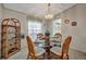 Charming dining room with a glass table, wicker chairs, and a decorative light fixture at 106 N Saint George Cir, Apollo Beach, FL 33572
