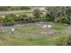 Aerial view of a fenced dog park with benches and picnic tables, offering residents outdoor recreation at 106 N Saint George Cir, Apollo Beach, FL 33572