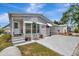 Charming single-story home with a front porch, carport, and well-manicured landscaping at 106 N Saint George Cir, Apollo Beach, FL 33572