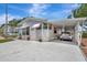 Charming single-story home with a carport, awning, and well-manicured landscaping at 106 N Saint George Cir, Apollo Beach, FL 33572
