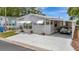 Charming single-story home with a carport, awning-covered windows, and a well-maintained yard at 106 N Saint George Cir, Apollo Beach, FL 33572