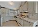 A kitchen with white cabinets, white appliances, and a window over the sink at 106 N Saint George Cir, Apollo Beach, FL 33572