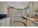 A kitchen featuring white cabinetry, a sink under the window, and essential appliances at 106 N Saint George Cir, Apollo Beach, FL 33572