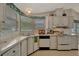Classic kitchen with white cabinets, matching appliances, and cozy corner design at 106 N Saint George Cir, Apollo Beach, FL 33572