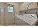 A laundry room featuring a washing machine, a dryer, and an exterior access door at 106 N Saint George Cir, Apollo Beach, FL 33572