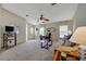 Comfortable living room featuring cozy furniture, natural light, and soft carpet at 106 N Saint George Cir, Apollo Beach, FL 33572