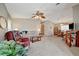 Cozy living room featuring carpet, a ceiling fan, and adjacent dining area at 106 N Saint George Cir, Apollo Beach, FL 33572