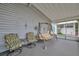 Cozy covered porch is furnished with comfortable seating and a swing, ideal for relaxation at 106 N Saint George Cir, Apollo Beach, FL 33572